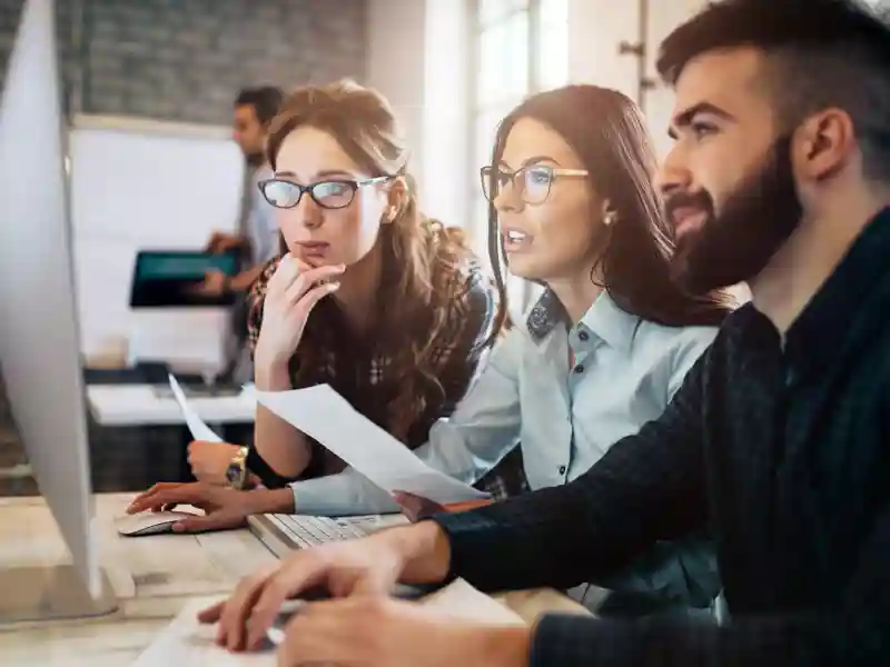 Employees using a desktop.